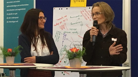 two people talking in front of project materials