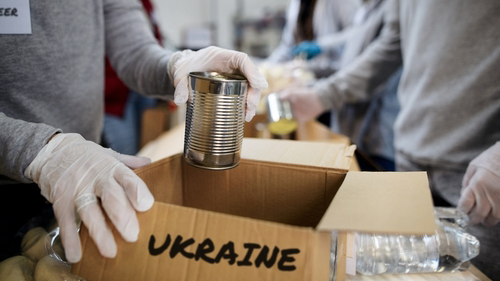 worker putting can in care package for ukraine