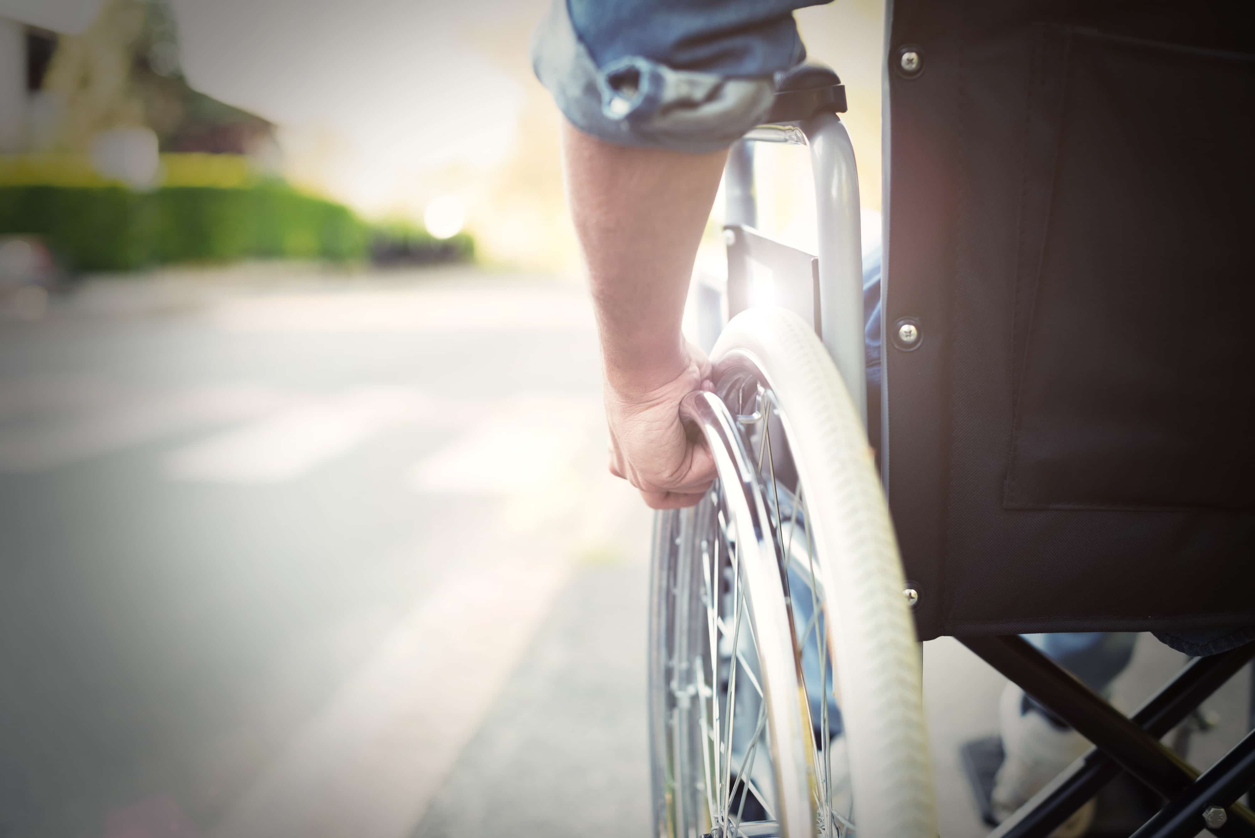 person in wheelchair on road