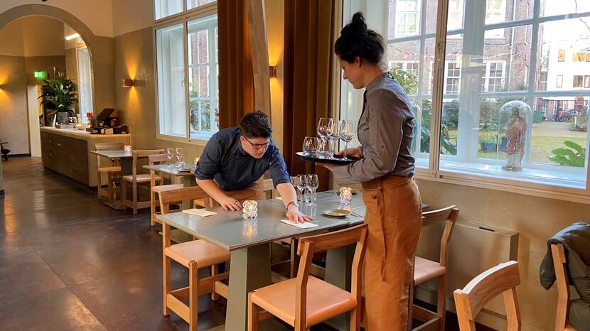 A trainee and a tutor working in the restaurant